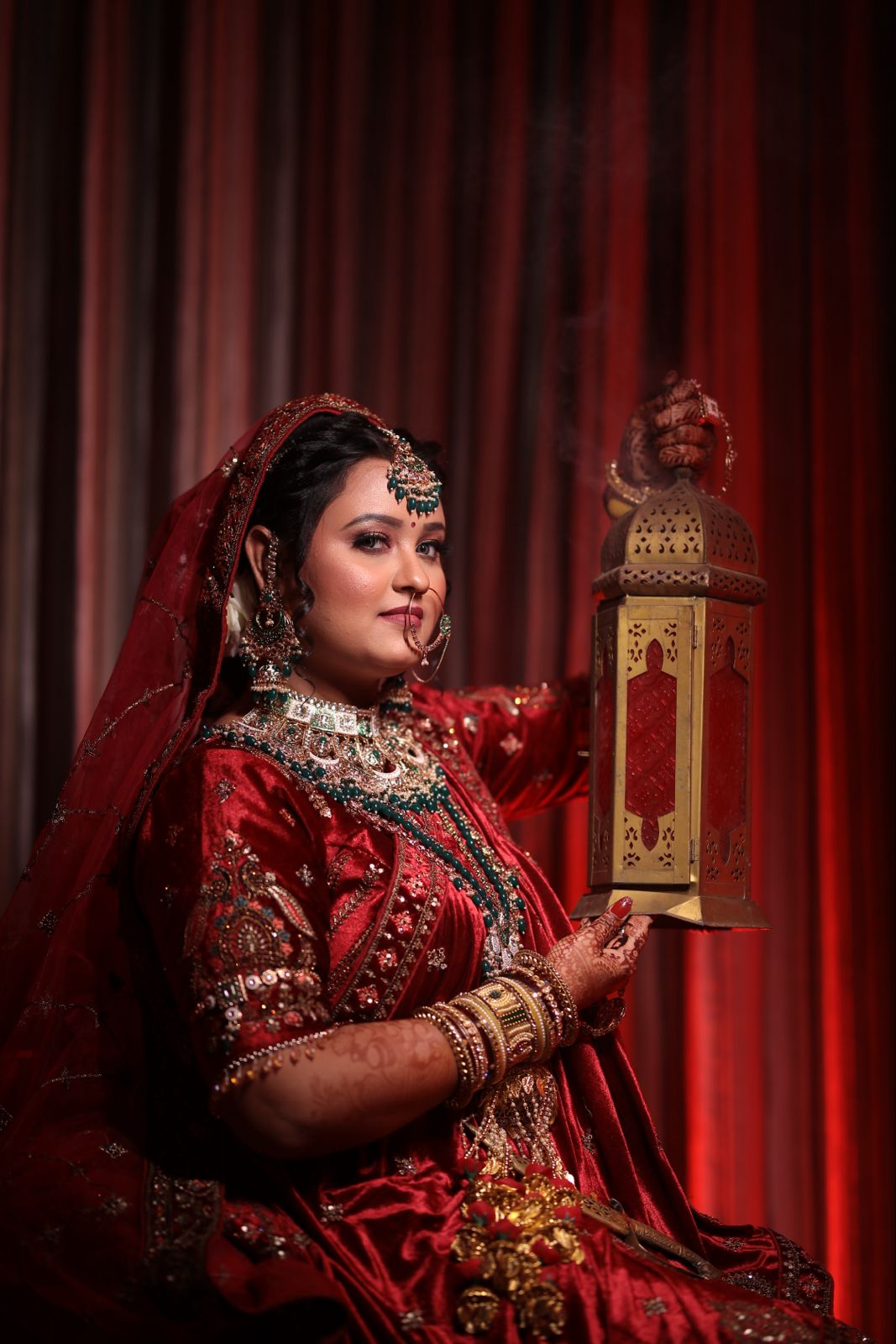 Bride in red holding a lantern