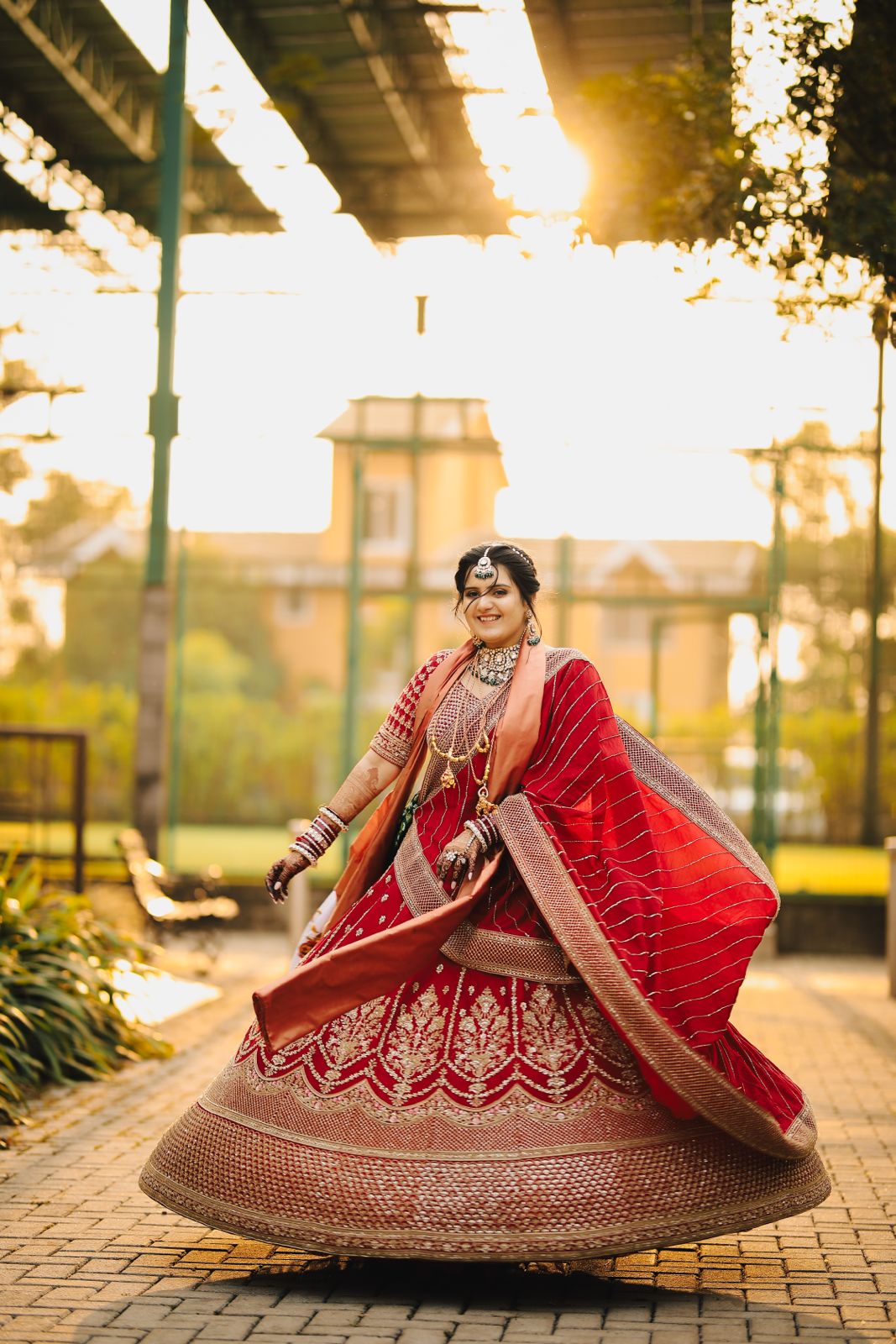 Bride twirling in red outdoors at sunset